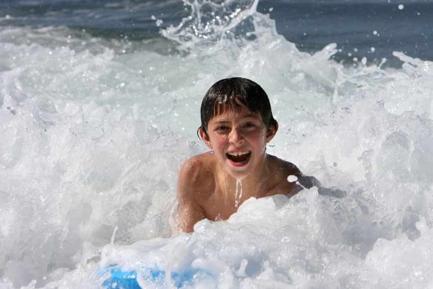 boy body surfing